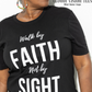 Model is wearing black t shirt Walk by faith not by sight white t shirt black letters